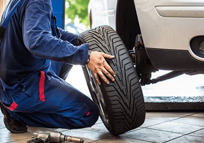 Mobile tire technician performing spare tire installation